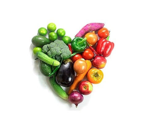 An assortment of colorful fruits and vegetables—such as bell peppers, tomatoes, cucumbers, broccoli, eggplant, apples, and limes—arranged in the shape of a heart on a white background, symbolizing health and nutrition.