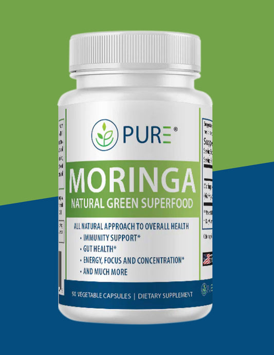 White bottle of PURE® Moringa Natural Green Superfood supplement, featuring a green and blue label. The label highlights benefits like immunity support, gut health, and improved energy, focus, and concentration. The product contains 90 vegetable capsules and is marketed as an all-natural dietary supplement.