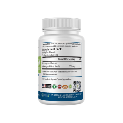 Left side view of PURE® Moringa supplement bottle showing the Supplement Facts label. Each capsule contains 550mg of Moringa Leaf Extract (Moringa oleifera). Suggested use recommends one to two capsules daily with a meal. Bottom of the label displays certification icons: Made in USA, GMP, Non-GMO, Lab Tested, and eco-friendly. Company contact information and QR code are also visible.